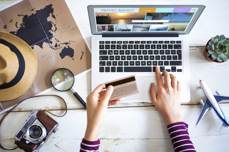 Traveler using a laptop with a VPN for secure internet browsing while traveling