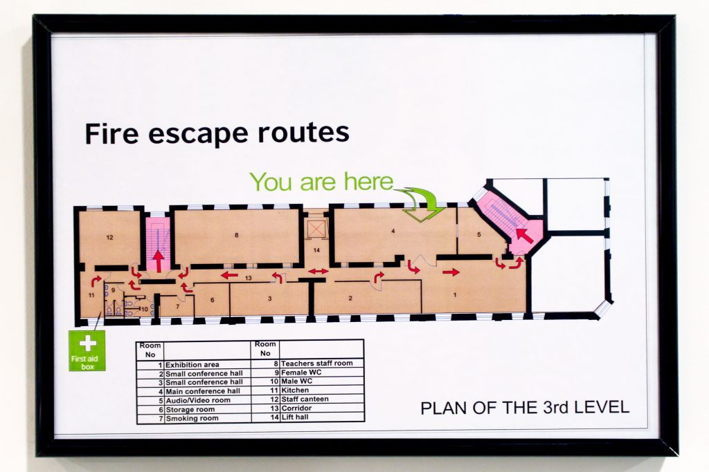 Emergnecy exit map on back of a hotel room door showing fire escape route