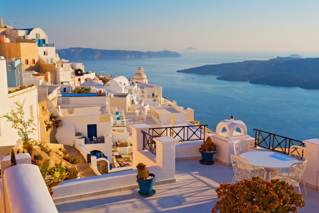 A scenic view of the caldera on Santorini island, representing a peaceful European pivot for tourists adjusting their itineraries amidst global travel disruptions.