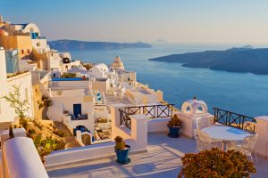 A scenic view of the caldera on Santorini island, representing a peaceful European pivot for tourists adjusting their itineraries amidst global travel disruptions.